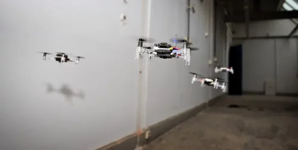 a group of small drones flying in the air