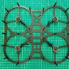 a drone frame on a green mat