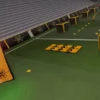Drone simulation game showing an indoor race track with obstacles, flags, and timing details